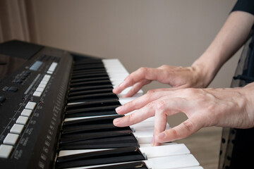 Close-up of the woman hand On Digital Piano Keyboard