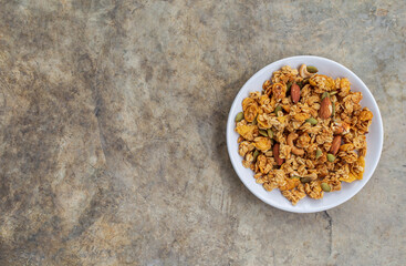 Homemade granola cereal with oatmeal, almond, cashews nut and pumpkin from top view.