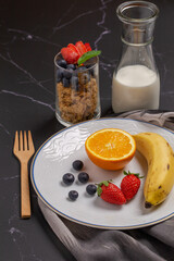 Fresh fruit for healthy breakfast on black table