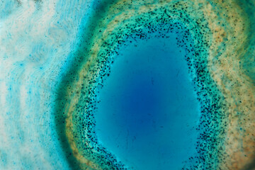 Agate stone bright blue macro background.Natural texture of blue stone. wallpaper nature.surface of agate stone.Abstract beautiful background in blue and green tones.
