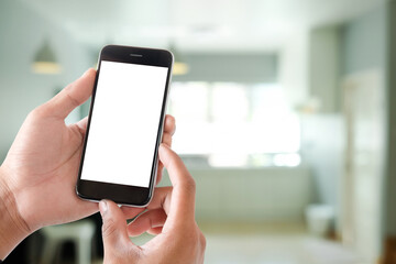 Cropped shot view of man hands holding smart phone with blank copy space screen for your text message or information content, female reading text message on cell telephone during in urban setting. 
