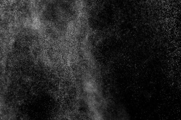 Abstract splashes of water on black background. Freeze motion of white particles. Rain, snow overlay texture.