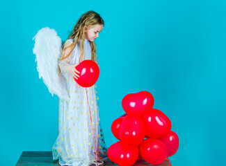 Kids Valentines Day. Looks like an angel. Angel kid with blonde curly hair. Cute child girl in...