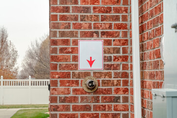 Brick wall with arrow pointing to fire sprinkler