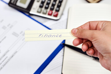 Man tearing paper with word - Finance. Concepts of financial crisis, breakdown, world trade markets collapse. The world financial system after coronavirus crisis