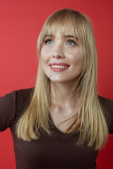 Blonde cheerful woman in brown t-shirt showing correct (right) modeling, posing. Beauty, fashion, youth concept