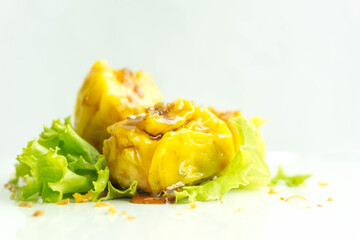 Fresh dumpling with sauce on white background