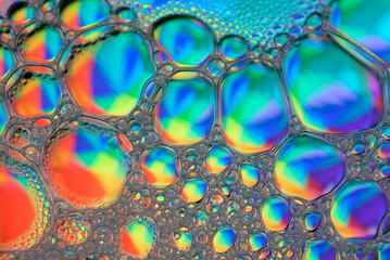 Beautiful bubbles from mixing water, oil and soap. Macro photography. Colorful bubbles. Abstract background. 