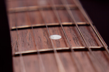 Macro photography to a six electric guitar strings and wooden fretboards. Vintage instruments and...