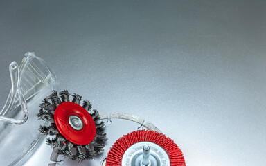 set of modern abrasive tools and protective safety glasses on grey metal