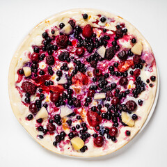 sweet pizza with berries on the white