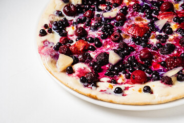 sweet pizza with berries on the white