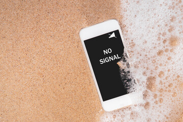 No signal words on smart phone at tropical sand beach texture background.