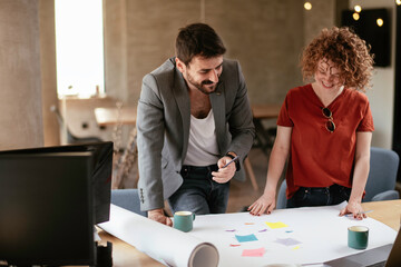 Colleagues in office. Businesswoman and businessman discussing work in office.