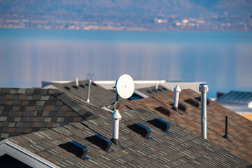 Television satellite dish mounted on a roof