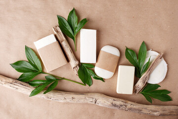 Zero waste natural cosmetics products on craft paper table. Flat lay, organic solid soap and shampoo bars, antibacterial handcrafted soap concept, mock up, organic detail, fern brunches