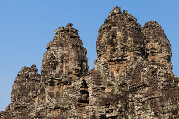Close up of famous faces at the facade of Bayon temple, center of Angkor Thom complex in Siem Reap,...