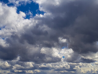 Heavy gray rain clouds in the blue sky. Atmosphere, air, cloudy, soon rain.