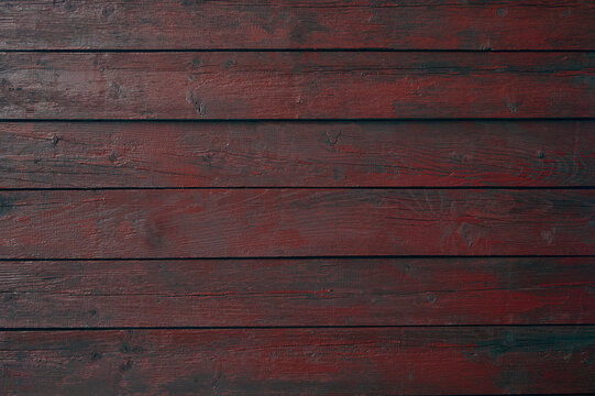Texture of old wooden boards painted with red paint