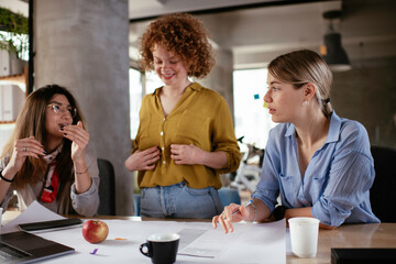 Fototapeta na wymiar Businesswomen working on a new project. Colleagues discussing about problem they have to solved.