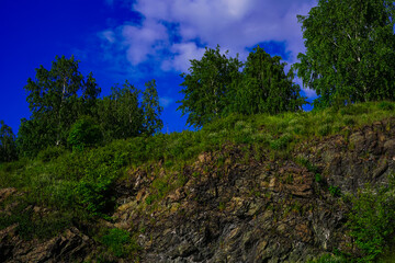 Fototapeta na wymiar Beautiful summer landscape of nature - rocks, greenery, blue sky