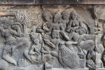 Wall carvings on stone at Prambanan hindu temples. Scenes about hindu gods and Ramayana texts. Temples located close to the city of Yogyakarta, island of Java, Indonesia, Southeast Asia