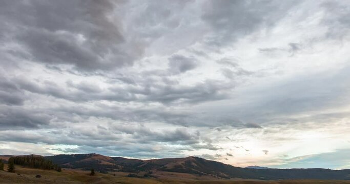 Time lapse shot of cloudy sky over natural landscape during sunset - Yellowstone National Park, Wyoming
