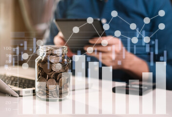 Accountant working on desk in office using calculator and laptop to calculate budget. concept finance and accounting in morning light.