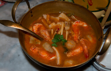 Tom yum prawn in young coconut soup.Tasty soup with prawns.Tom Yum Kung Prawn Thai Food. spicy prawn soup or tom yum goong