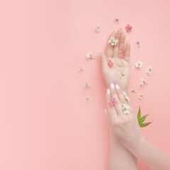 template for natural cosmetics, beautiful manicured woman hands and wildflowers