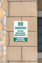 No Smoking sign on the exterior stone wall of apartment in Rock Creek Utah
