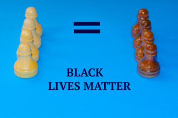 Black and white chess pieces on a blue background. The inscription Stop racism. Black lives matter! Motivational poster against racism and discrimination. High quality photo