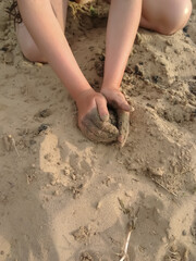 girl playing in the sand on the beach