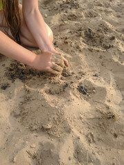 girl playing in the sand on the beach