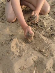 
girl playing in the sand on the beach
