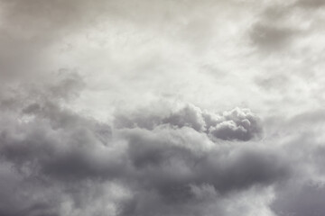 Natural toned emotional day sky background. Heavy cloud formation in stormy dark sky, strong wind and hard rain.