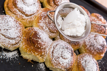 bakery fresh bun dusted powdered sugar. closeup