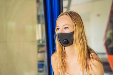 Naklejka premium young woman wearing a hygiene protective mask over her face while walking at the crowded place. Healthcare and sickness prevention from coronavirus, Covid19 influenza in crowded place