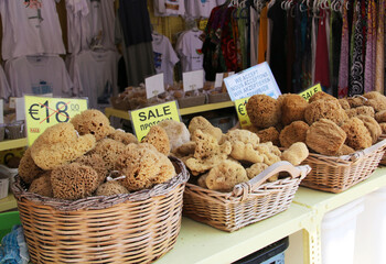 Sea sponges of different shapes and sizes sold at a small shop in Symi town, Symi island, Greece
