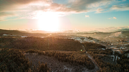 Carpathian mountains winter. Snow coniferous forest at sunset.
