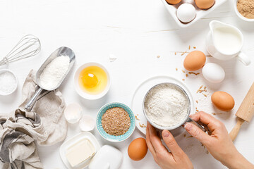 Baking homemade bread on white kitchen worktop with ingredients for cooking, culinary background, copy space, overhead view