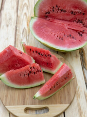 Fresh ripe sliced watermelon on wooden rustic background
