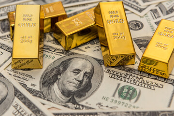 gold bars on the 100 dollar USD banknote as background