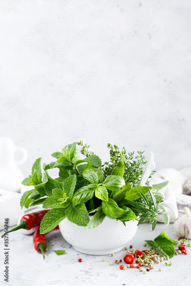 Wall mural bunch of aromatic herbs in mortar on kitchen table