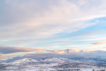 Fototapeta na wymiar Scenic Utah Valley landscape blanketed with snow under overcast blue sky