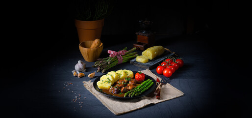 dumplings with beef goulash and green asparagus