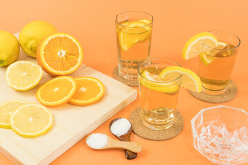 Glasses of cold tea with slices of orange and lemon