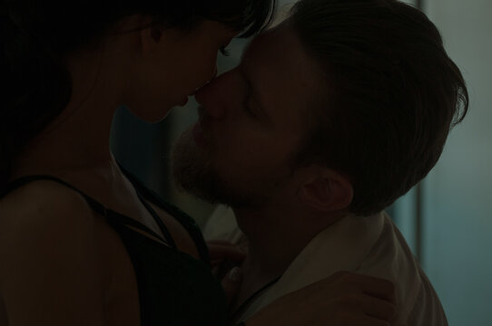 Man and Woman in the dark relationship love, kisses, hugs.