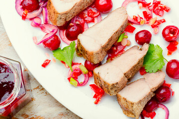 Pork with cherry sauce.
