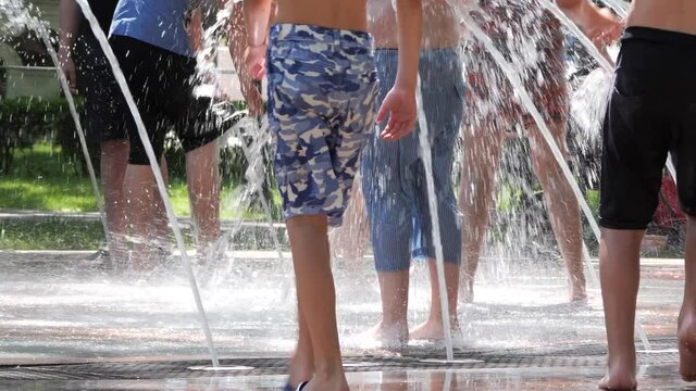 Gomel, Belarus - June 10, 2020: Children bathe in a fountain in the park Gromyko